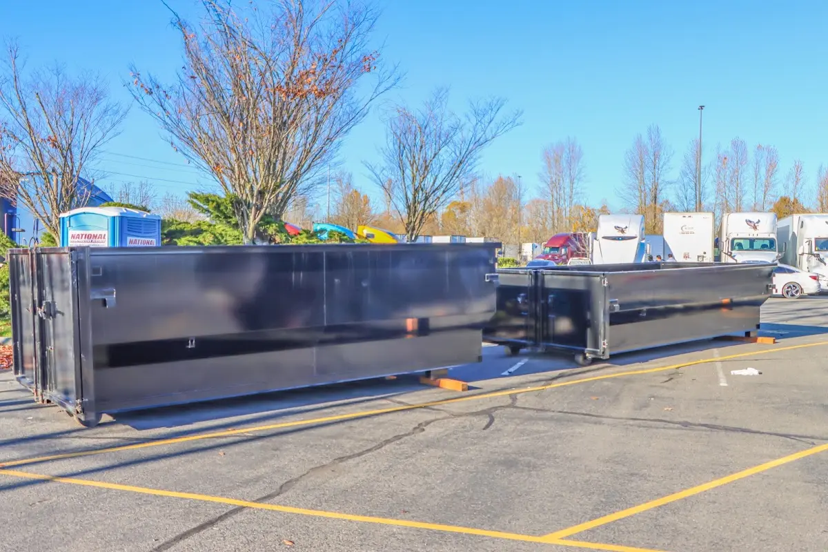 Professional dumpster rental service with roll-off container on residential driveway in Fairfield Glade